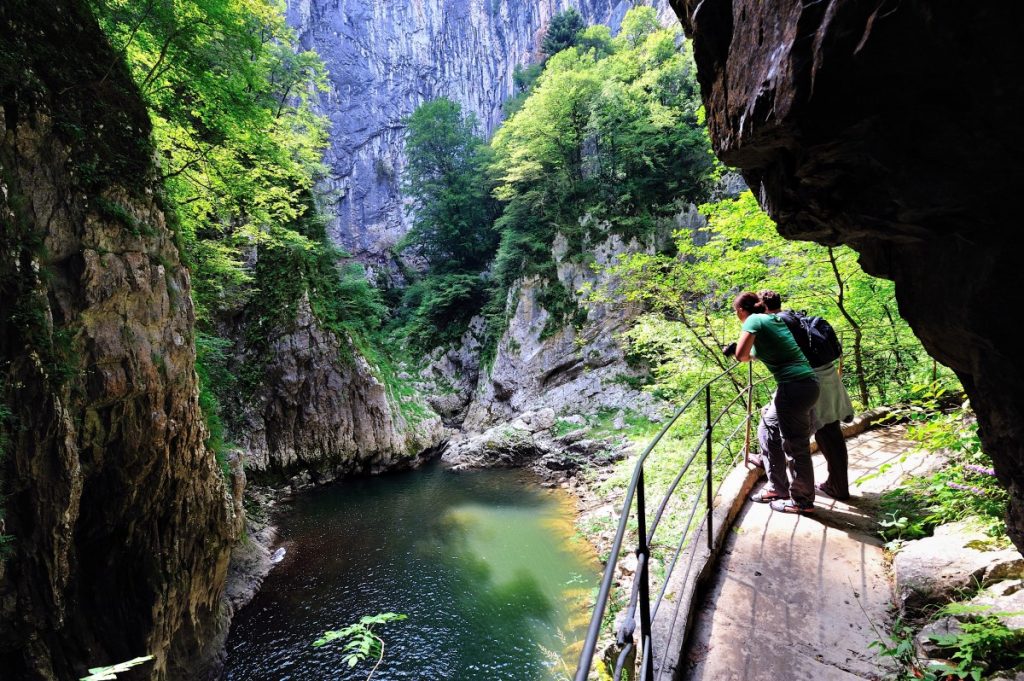 A picture of people hiking inside Karst-Phenomenom UNESCO Skocjan Caves. Book a day trip from Rovinj at www.krug-travel.com.